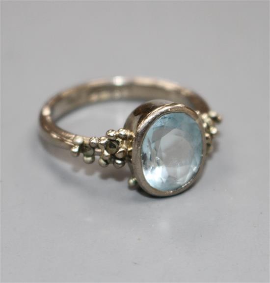 A modern 18ct white gold, aquamarine and marcasite set dress ring, size N, gross weight 5.8 grams.
